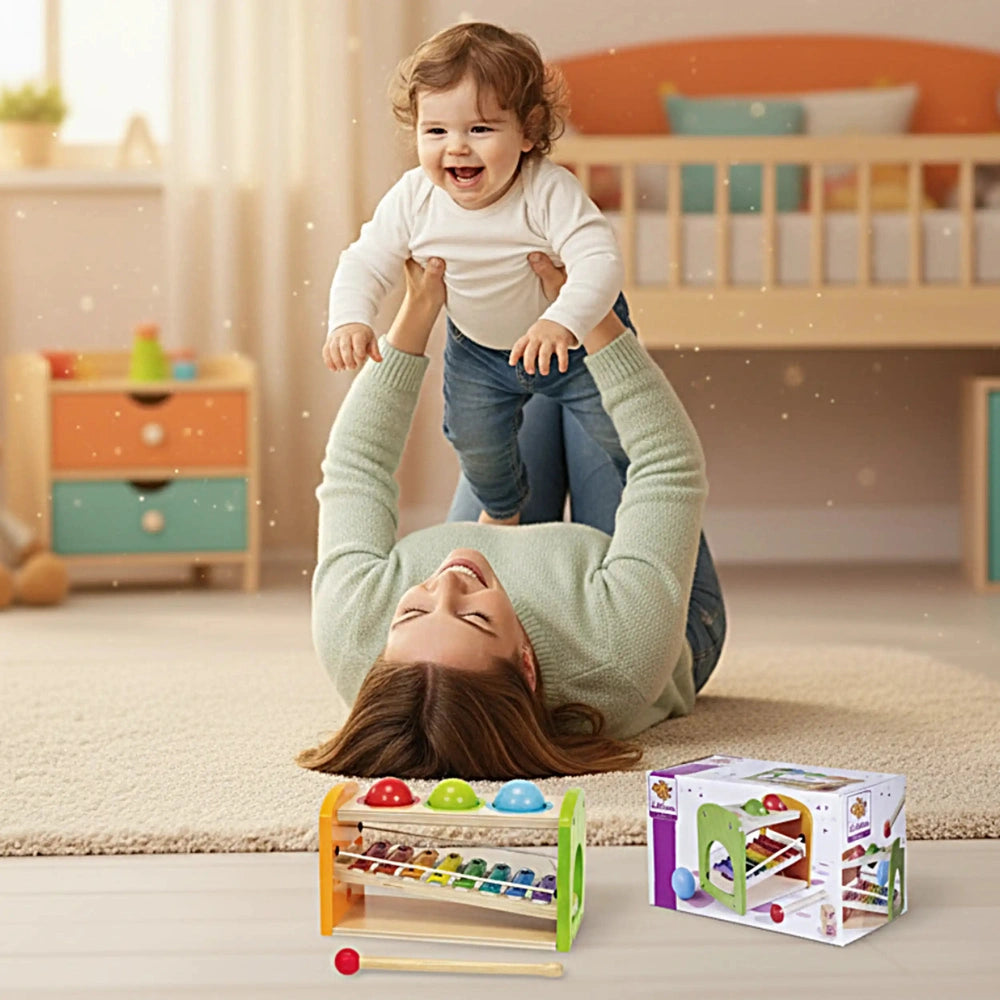 Eichhorn Hammer Bench with Xylophone alongside a joyful baby and woman in a warm, inviting indoor playroom setting.