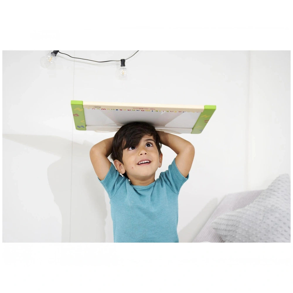 Eichhorn Magnetic and Chalkboard educational toy with a smiling child holding it up indoors, featuring soft lighting.