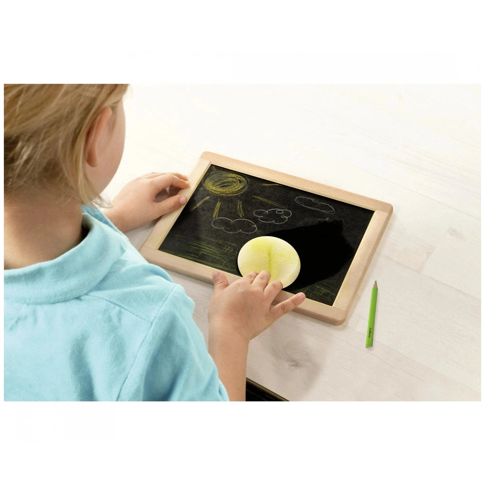 Eichhorn Small Blackboard - Child engaged in activity with blackboard and yellow fruit object at a table.
