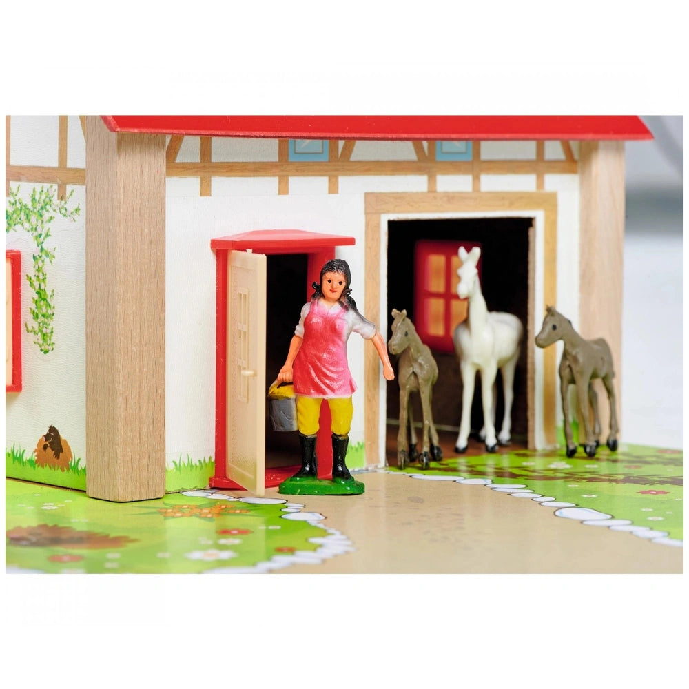 Eichhorn Wooden Farm playset featuring a dolhouse, toy horses, and a girl figure in a colorful outdoor scene.