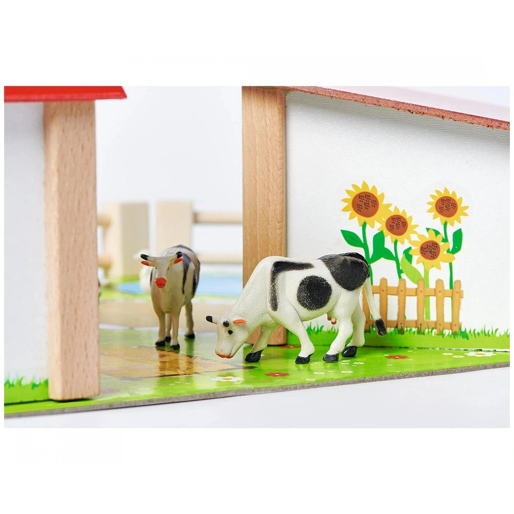 Eichhorn Wooden Farm with Accessories showcases a red-roofed house, toy cows, and a green lawn setup, perfect for imaginative