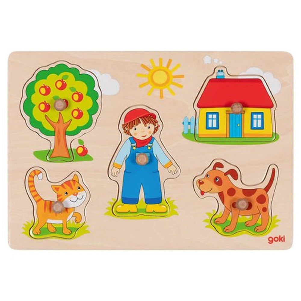 GOKI Cat Dog Lift-Out Puzzle packaging features a boy with a blue shirt and red hat, surrounded by a vibrant outdoor scene.