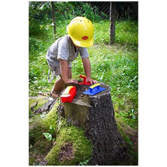 Gowi Design Bricklaying Set features a person in a yellow hard hat holding a red and yellow tool on a mossy stump.