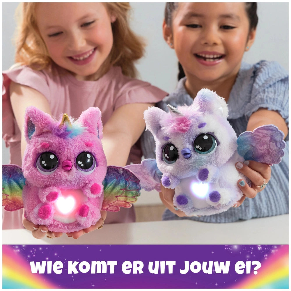 Hatchimals Alive Mystery Hatch Pufficorn plush toys in pink and blue held by two young girls indoors, showcasing their vibran