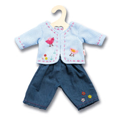 Heless jacket with denim shorts, featuring a blue knitted vest and pink embroidered floral patterns, displayed on a wooden ha