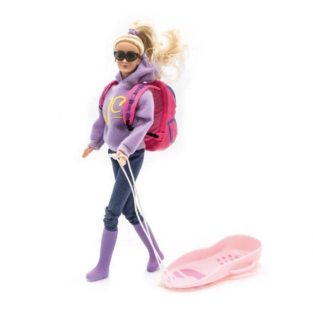 Jagerndorfer doll with long blonde hair, wearing a purple hoodie, blue jeans, and pulling a pink sled with a pink and purple 