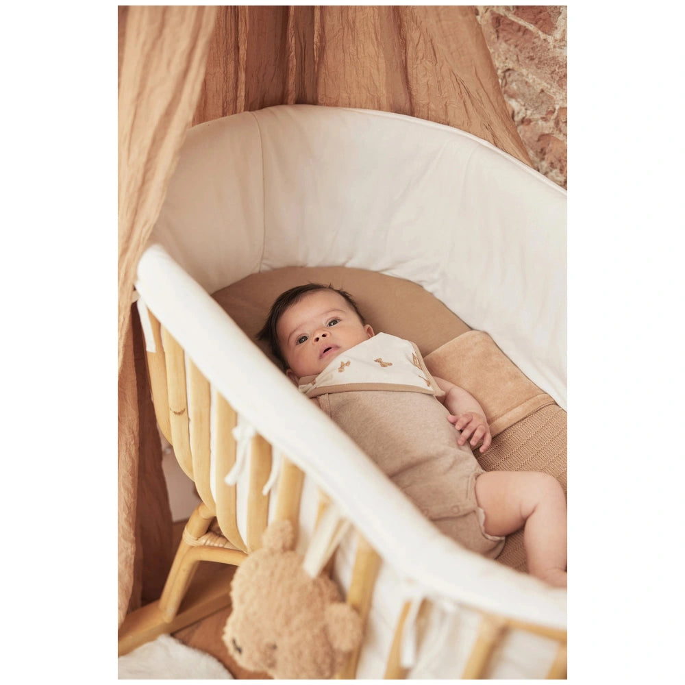 Jollein Bib Bandana Teddy Bear 2 Pack displayed in a cozy crib with a baby and a stuffed bear, featuring soft fabric material