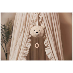 White teddy bear hanging from a string in a close-up view, designed for Jollein musical hanger stuffed animals.