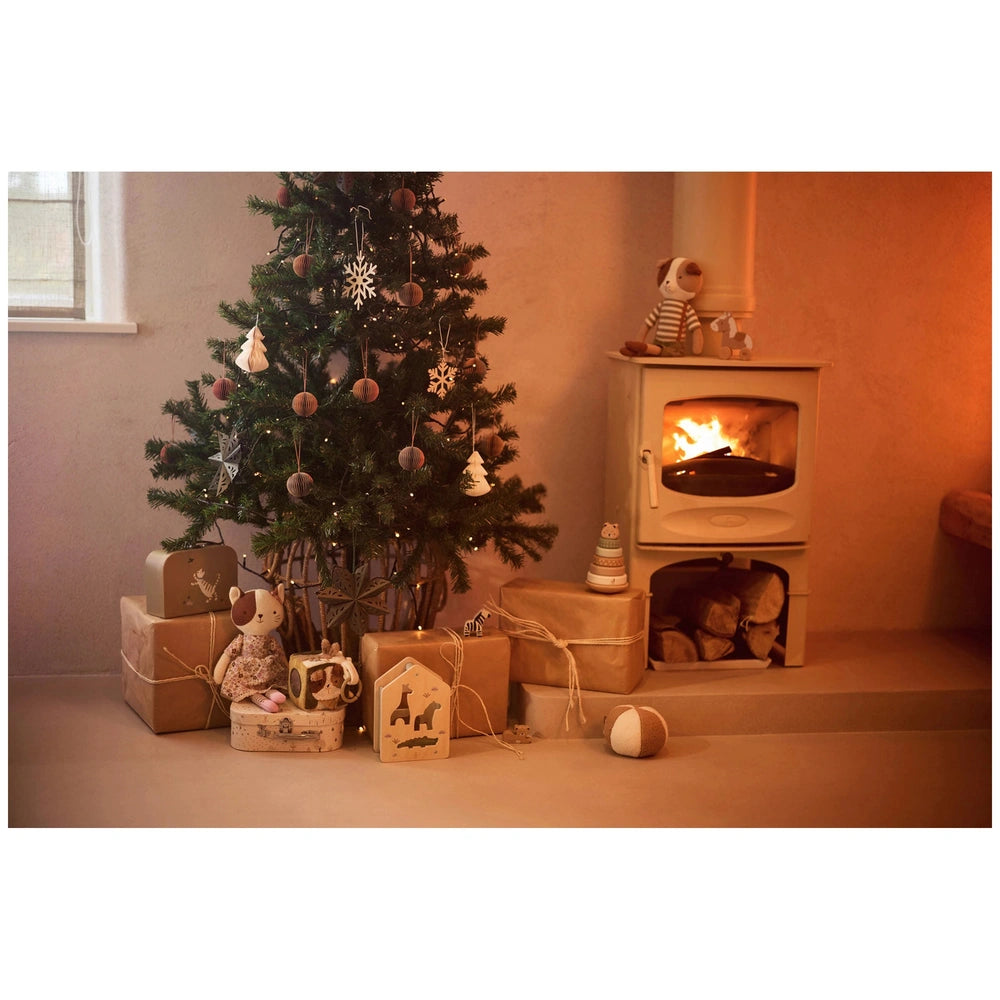 Jollein pacifier cloth featuring animal friends, nestled among Christmas decorations and a cozy wooden setting.