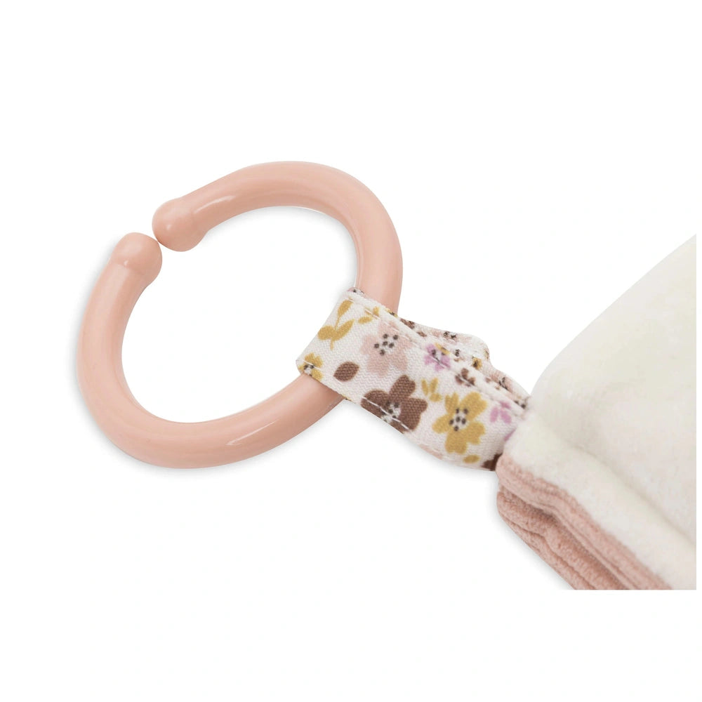 Jollein Soft Activity Book features a light pink flexible handle attached to a fluffy, multicolored floral fabric surface.