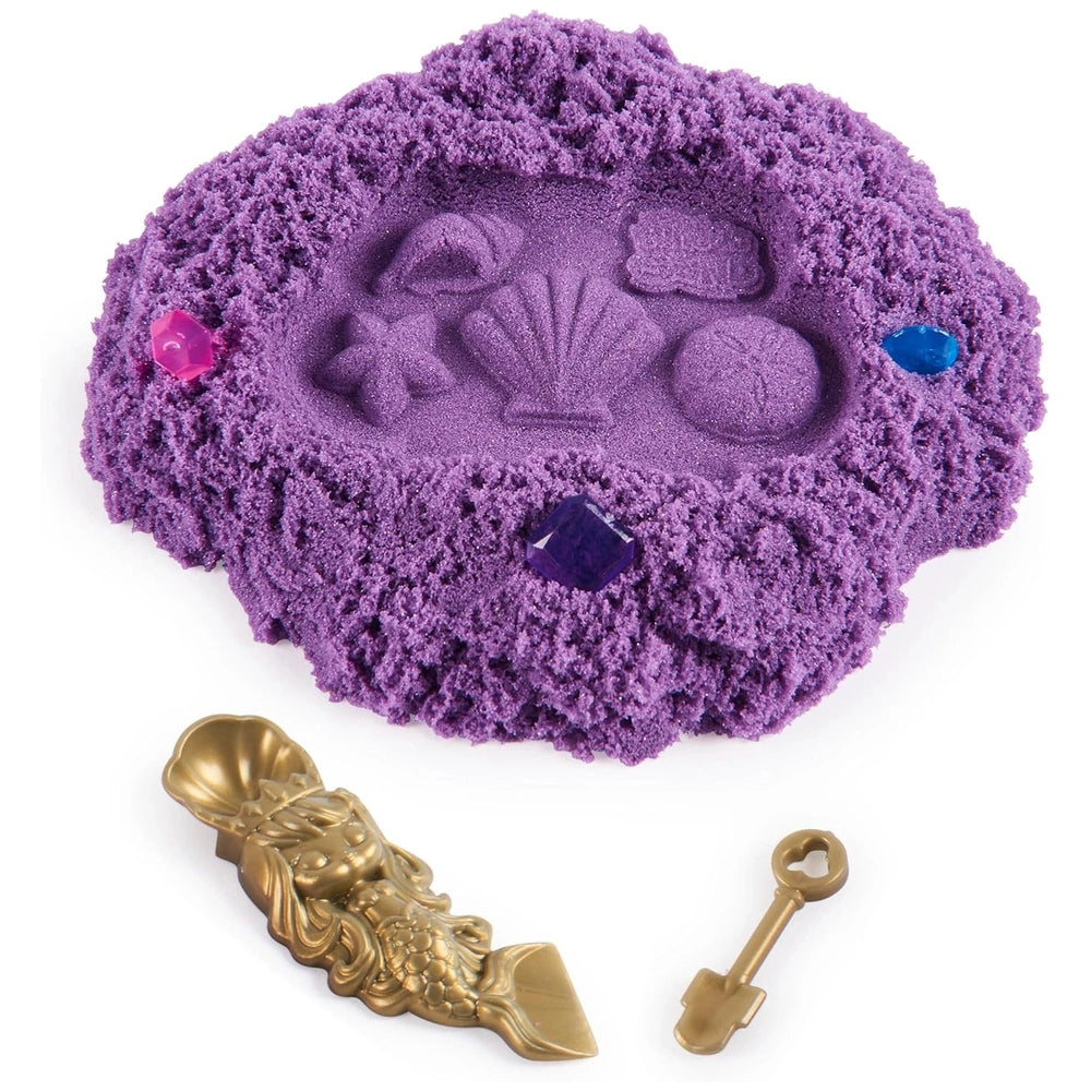 Kinetic Sand Mini Mermaid Lock is displayed on a deep purple, plush play mat with sculpted shapes and colorful decorative sto