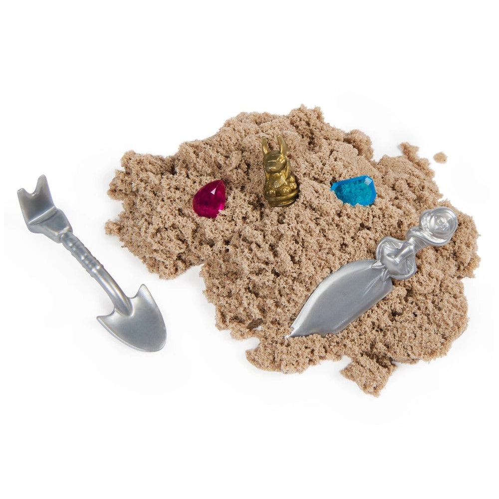 Kinetic Sand Mummy Tomb set with a silver shovel and colorful sandcastle components featuring red and blue gemstones.