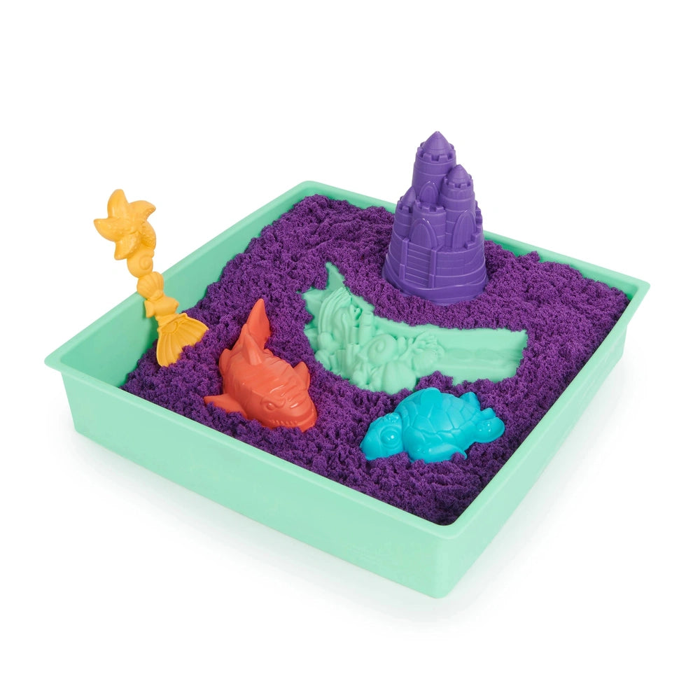 Kinetic Sand Sandbox Set features vibrant purple sand in a plastic container with a yellow flower and purple castle toy on to