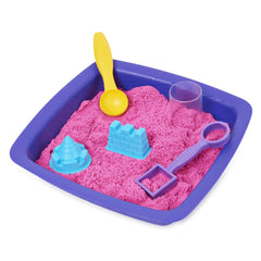 Kinetic Sand Shimmer Sparkle Sandcastle Set features pink sand in a blue tray with a blue castle, yellow spoon, and clear cup