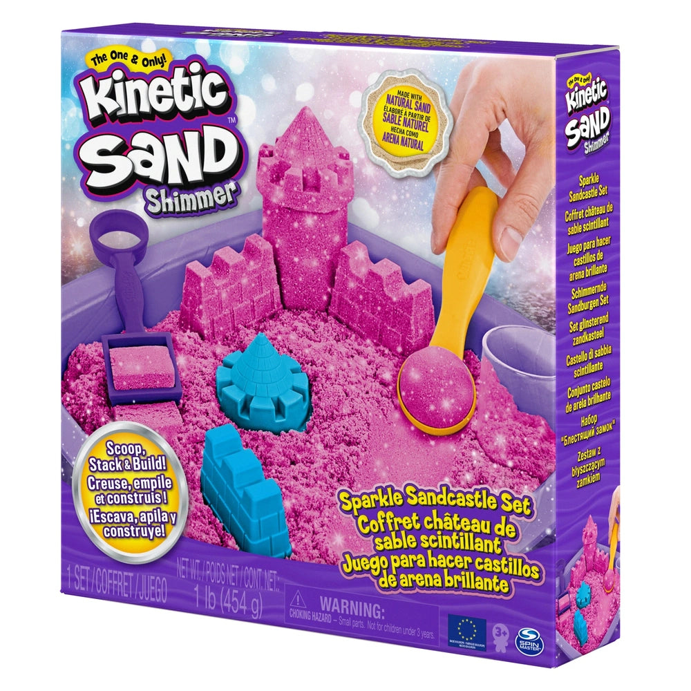 Kinetic Sand Shimmer Sparkle Sandcastle Set box features a pink sand castle graphic, a hand with a yellow shovel, and a starr