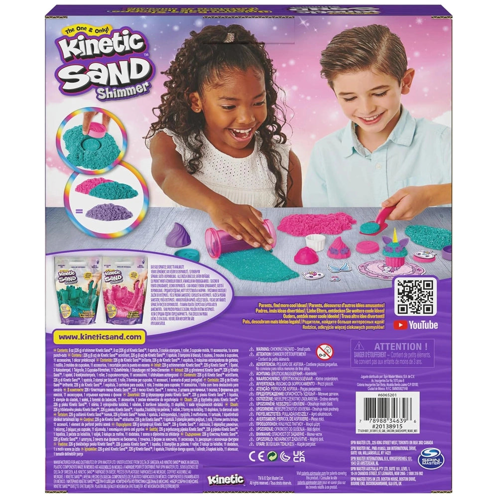 Kinetic Sand Unicorn Bake Shoppe packaging features two smiling children with colorful containers, set against a bright pink 
