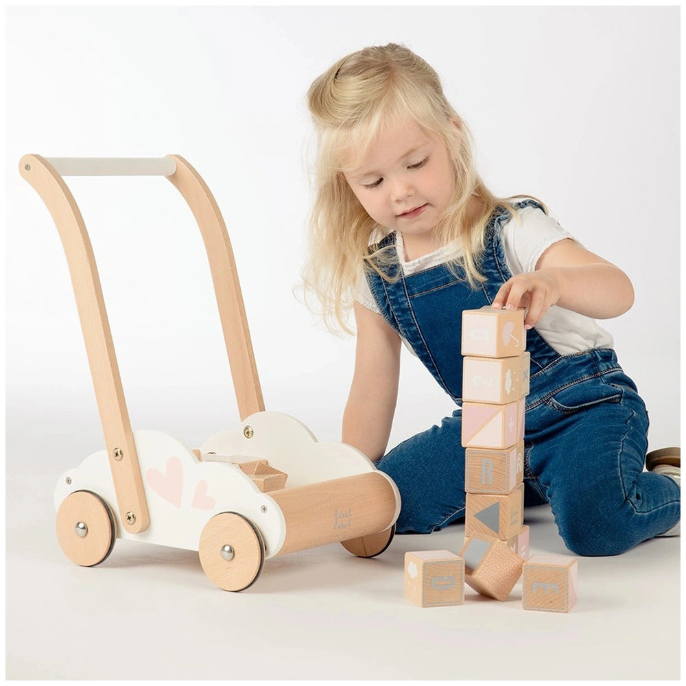 Educational Baby Walker with a white wooden toy car and blocks, featuring a young girl in denim overalls and a white t-shirt.