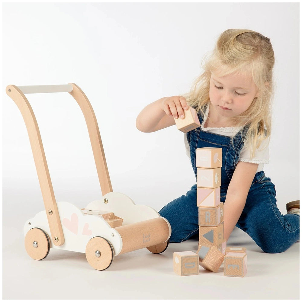 Label-Label educational baby walker features a young girl interacting with colorful wooden toy train tracks and train compone