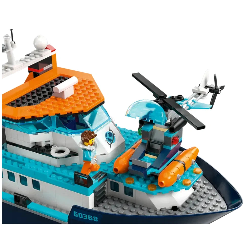 Colorful LEGO® City Arctic Explorer Ship with a helicopter on deck, featuring a minifigure in a blue outfit and orange pants.