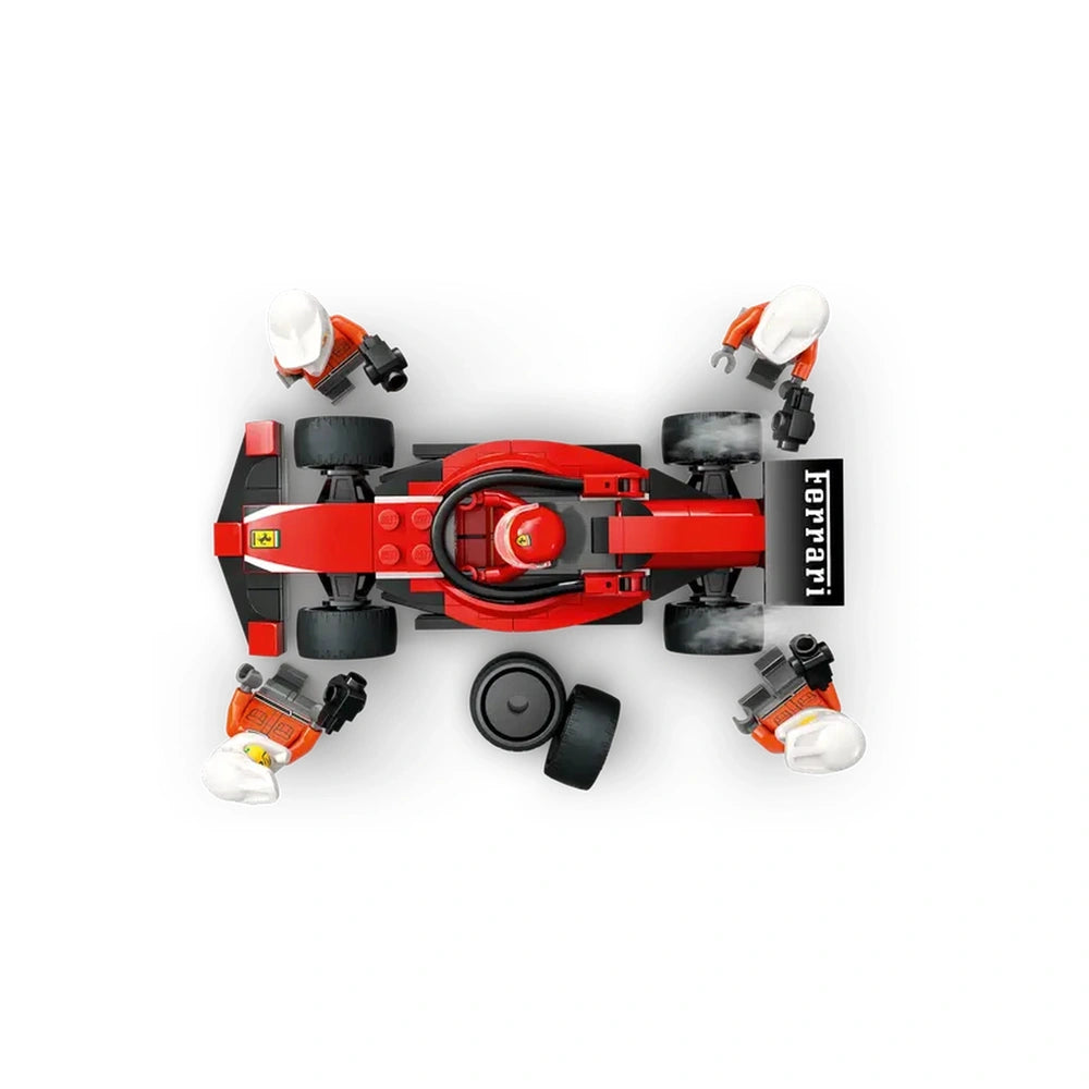 Red LEGO Ferrari race car at a pit stop, surrounded by four pit crew minifigures. Tires and tools are scattered nearby, ready for action.