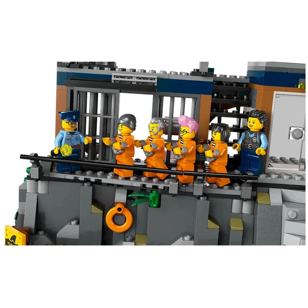 LEGO® City Police Prison Island set features a prison scene with five orange-clad prisoners being escorted by a police officer. The cliffside prison has bars and a control room in the background.