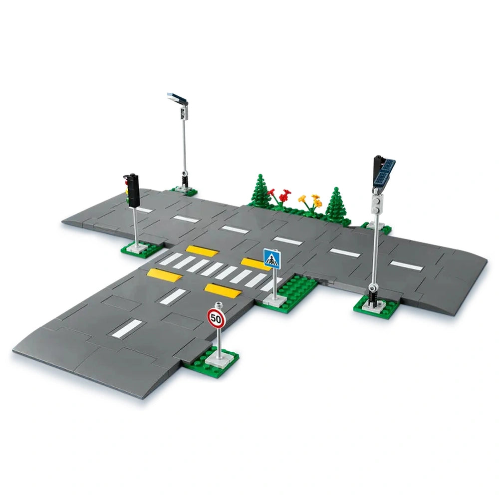 LEGO City Road Plates set featuring grey road plates with white lane markings, yellow speed bumps, traffic lights, and green trees.