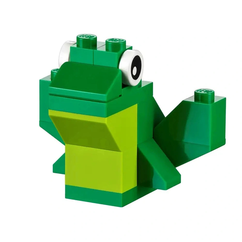 Green LEGO frog model with a smiling mouth, large eyes, and vibrant green bricks, showcasing imagination and creativity.