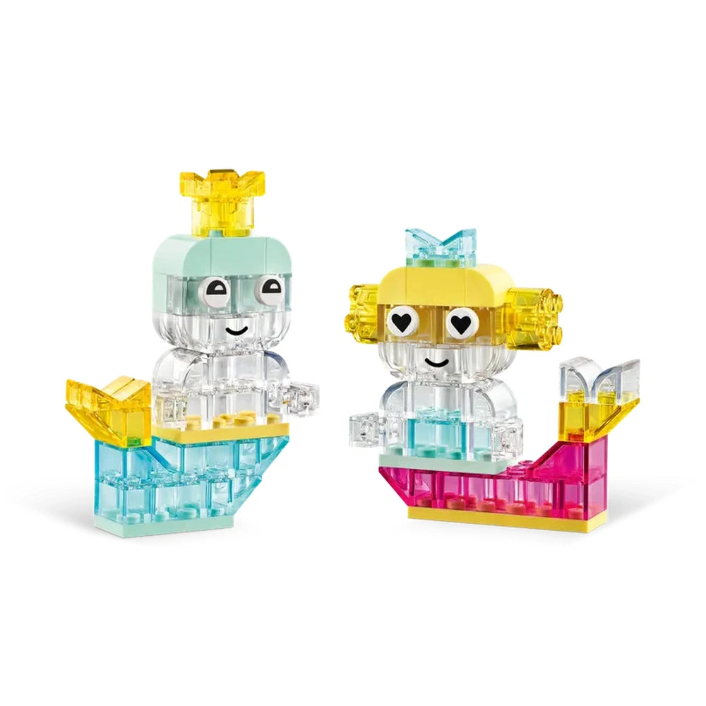 Two colorful LEGO® mermaid figures with translucent elements, featuring a blue and yellow color scheme on small bases.