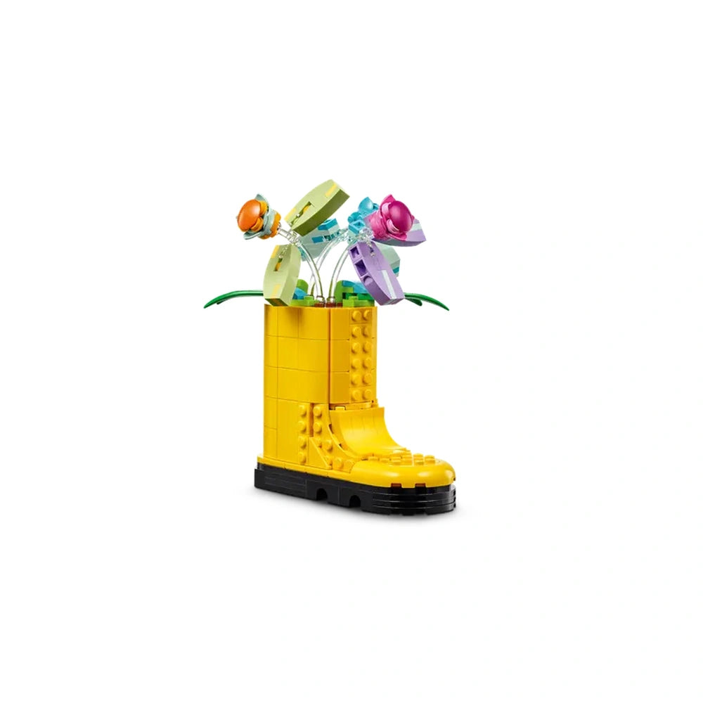 Bright yellow LEGO® watering can shaped like a boot holds colorful flower toys with movable petals and transparent butterfly accents.