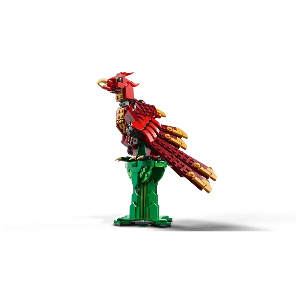 Colorful LEGO® Creator phoenix model with red and gold feathers, perched on a green base, showcasing intricate detailing.