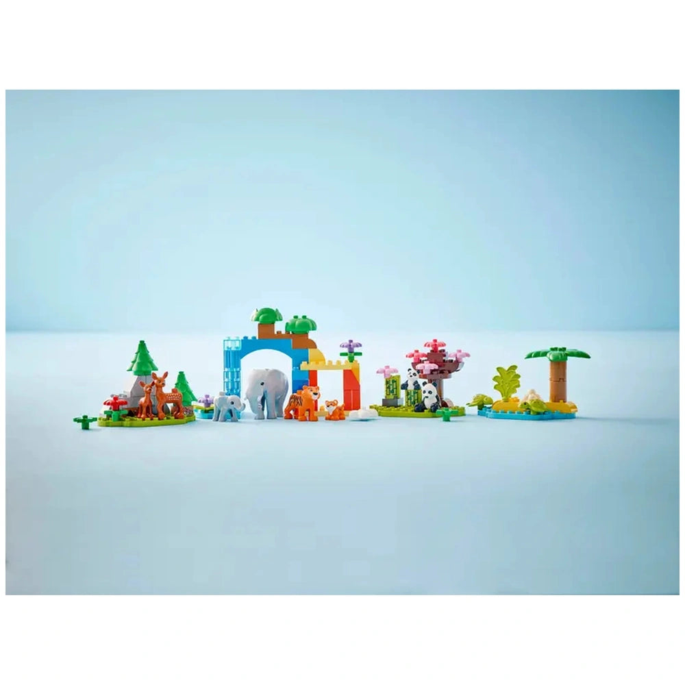 Colorful LEGO® DUPLO® 3in1 Wild Animal Families set featuring playful animal figures, trees, and a vibrant archway amidst a serene backdrop.
