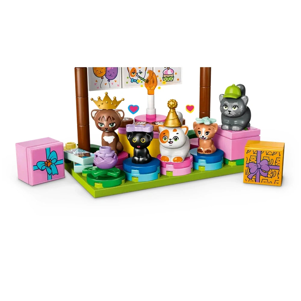 Colorful LEGO Friends Cat Birthday Party scene featuring six playful cat figures, birthday decorations, and wrapped gifts on a green base.