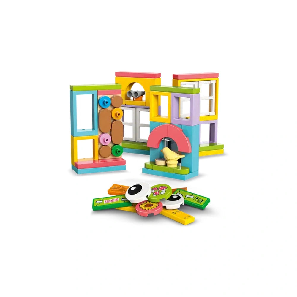 Colorful LEGO bricks assembled into various playful structures, featuring windows, arches, and round shapes, with vibrant accessories scattered around.