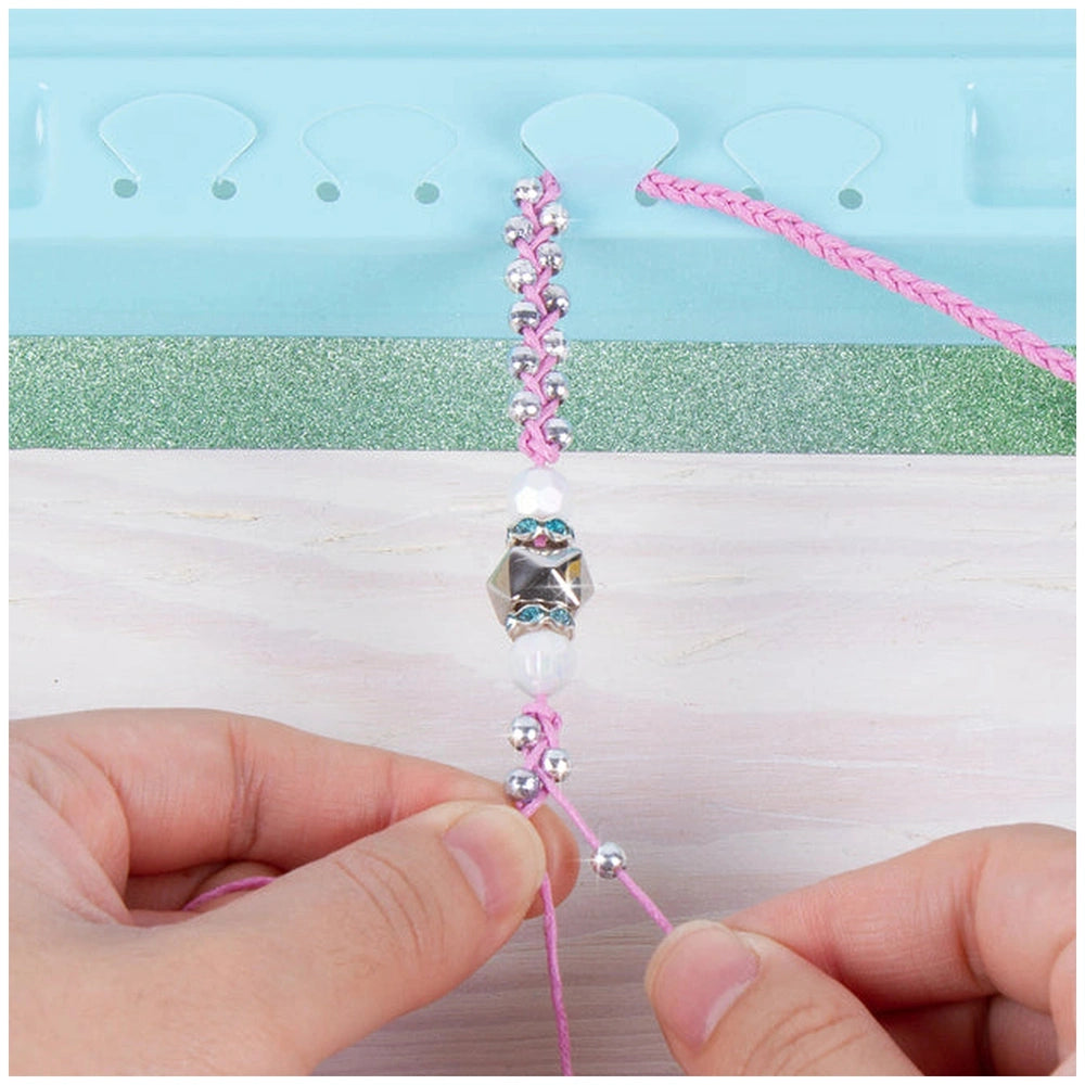 Rainbow Bling Bracelets made of translucent and metallic beads held by hands, showcasing a colorful craft item.