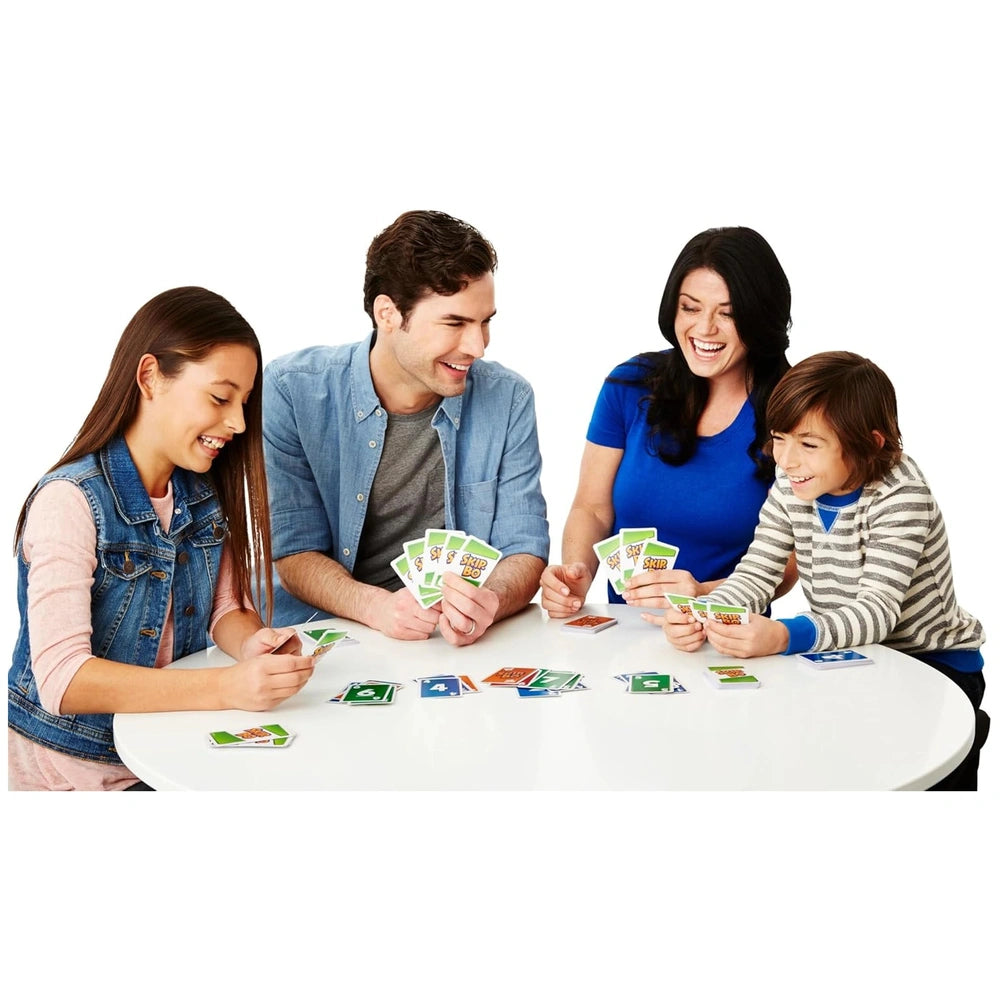 Mattel Skip-Bo Ultimate Sequencing Card Game being played by four people around a white table with colorful clothing and visi