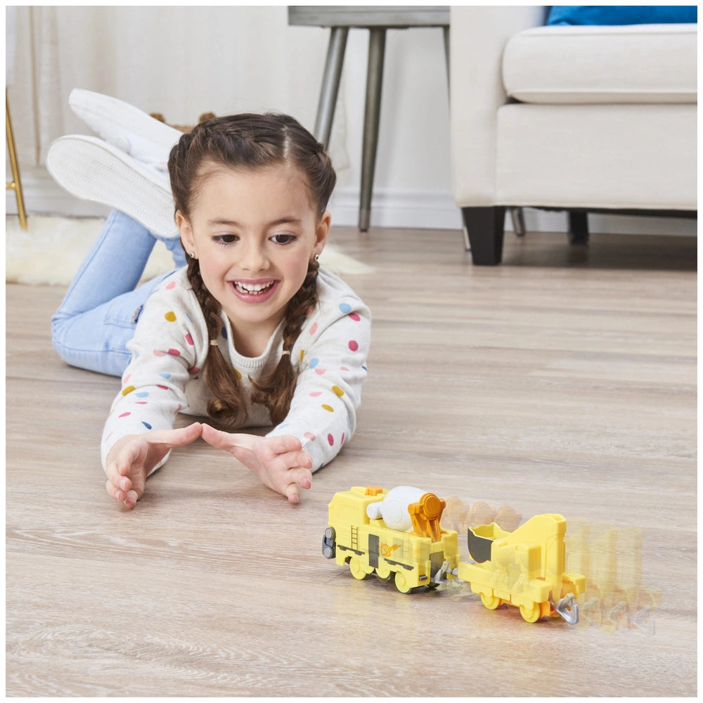 Mighty Express Motorized Train with a smiling girl in colorful polka dots shirt playing on light wood floor.