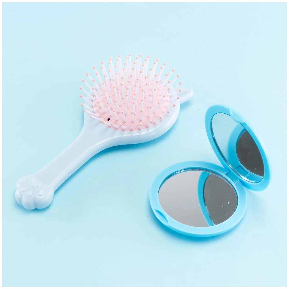 Momomi Decoden Kawaii Artist creamy mirror with blue frame and brush featuring a white handle and pink bristles.