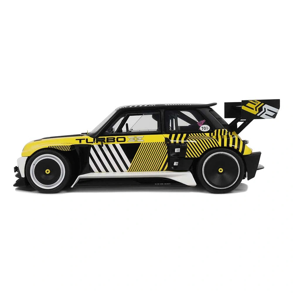 RC Renault 5 Turbo 3E with glossy yellow and black stripes, transparent windows, and silver wheels featuring yellow centers.