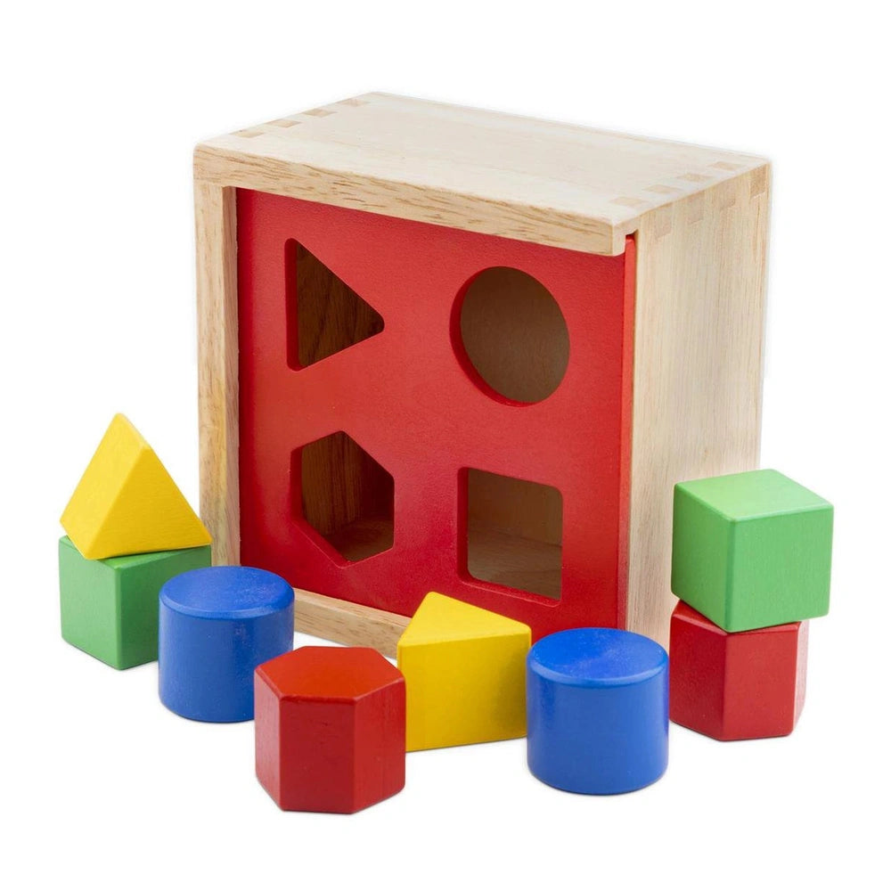 Colorful shape sorter toy with a wooden base, featuring red, yellow, and green plastic shapes for baby activity.