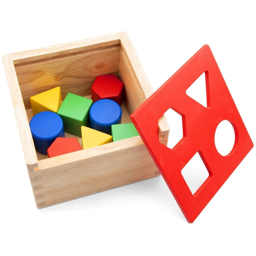 Colorful shape sorter with a wooden box and plastic pieces in blue, green, red, and yellow arranged inside.