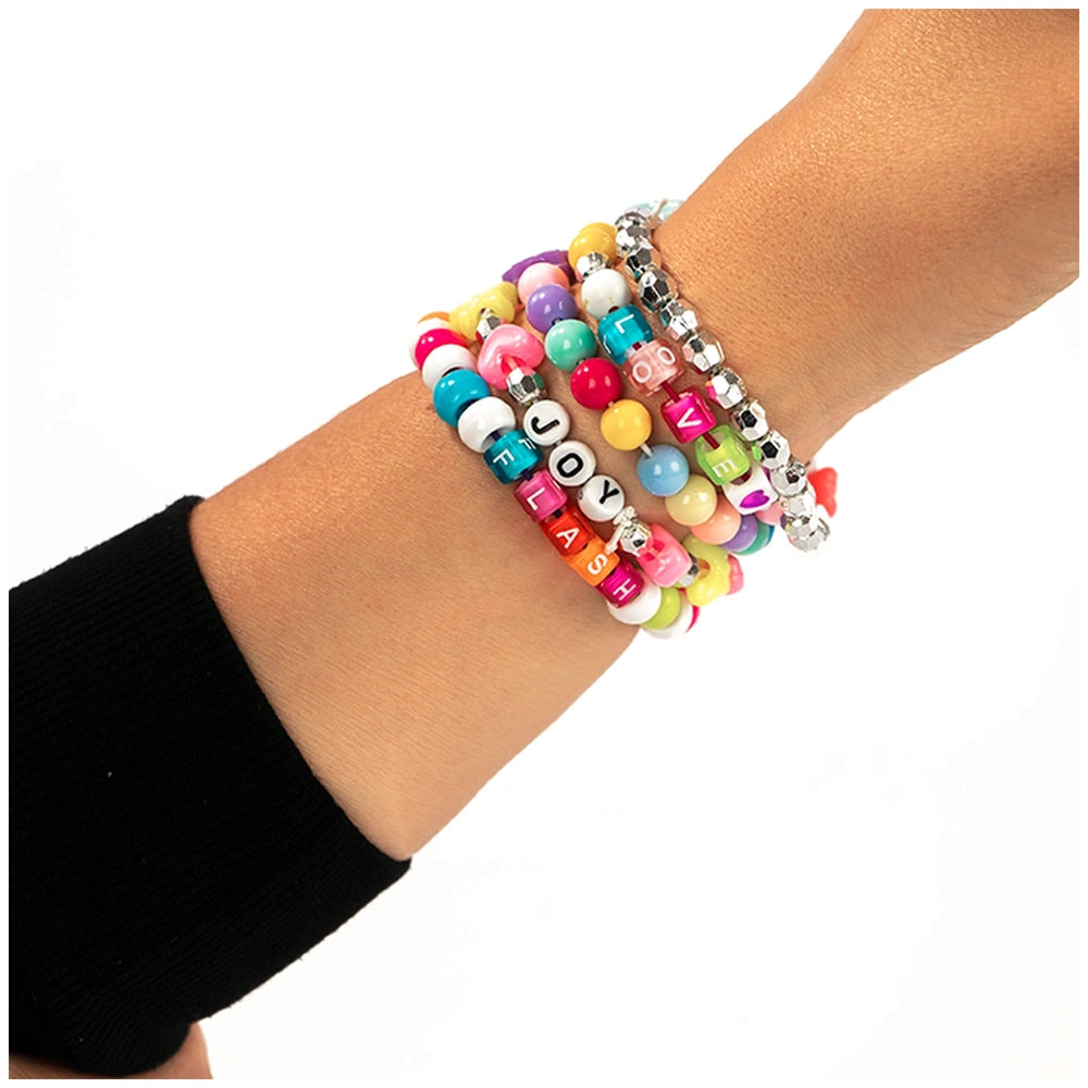 Colorful and silver beads arranged on black fabric for the Nice - Beads Abc Pcs 500 Fluo Set in arts and crafts.