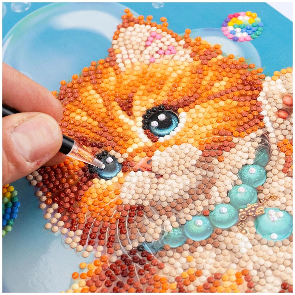 NICE Diamantiny Pets Coloring Arts Crafts features colorful beads arranged into a cat's face on a clear, smooth surface.