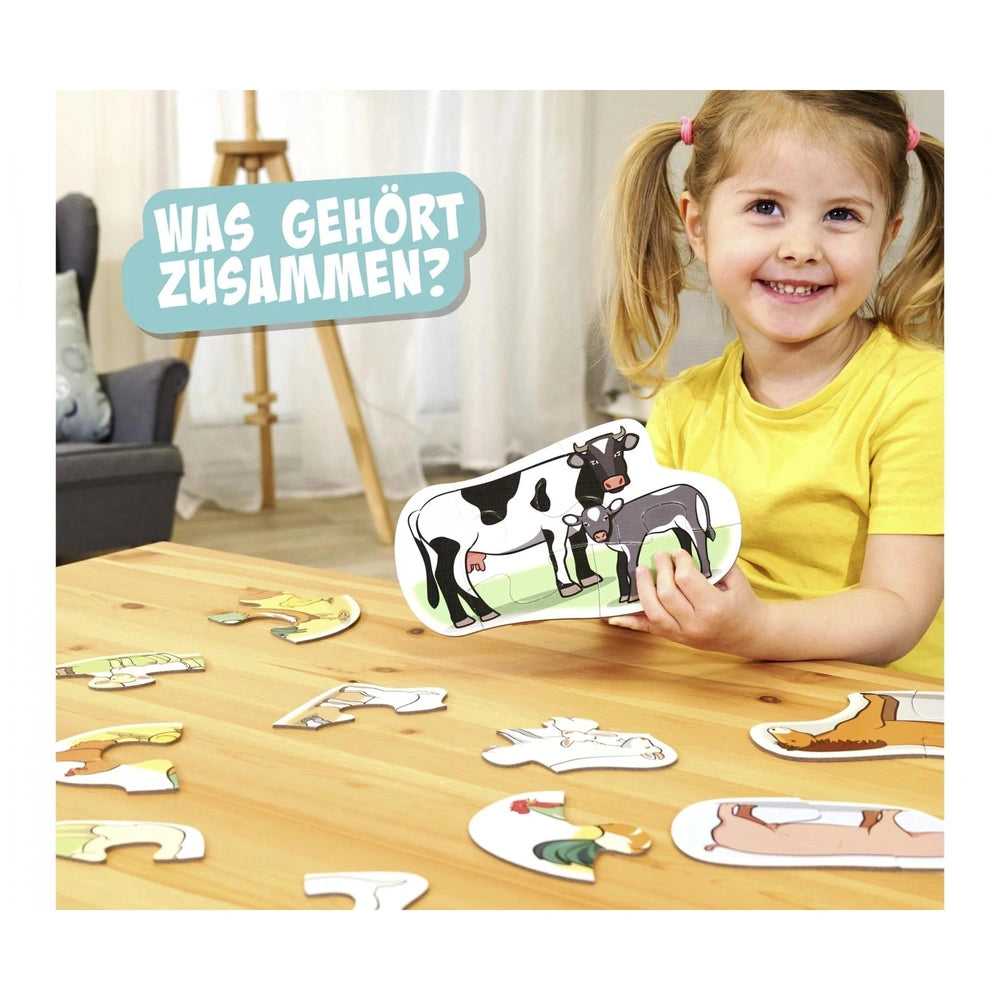 Noris first puzzles featuring farm animals, a girl engaged with colorful animal cards in a bright, homey setting.