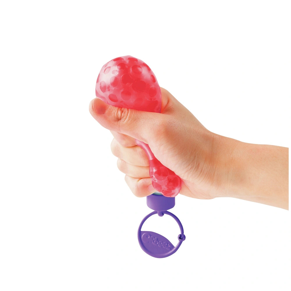 Orbeez Water Beads Surprise Activity Orb Set held in a hand, featuring a red and purple soft, rubbery design with a hollow ce