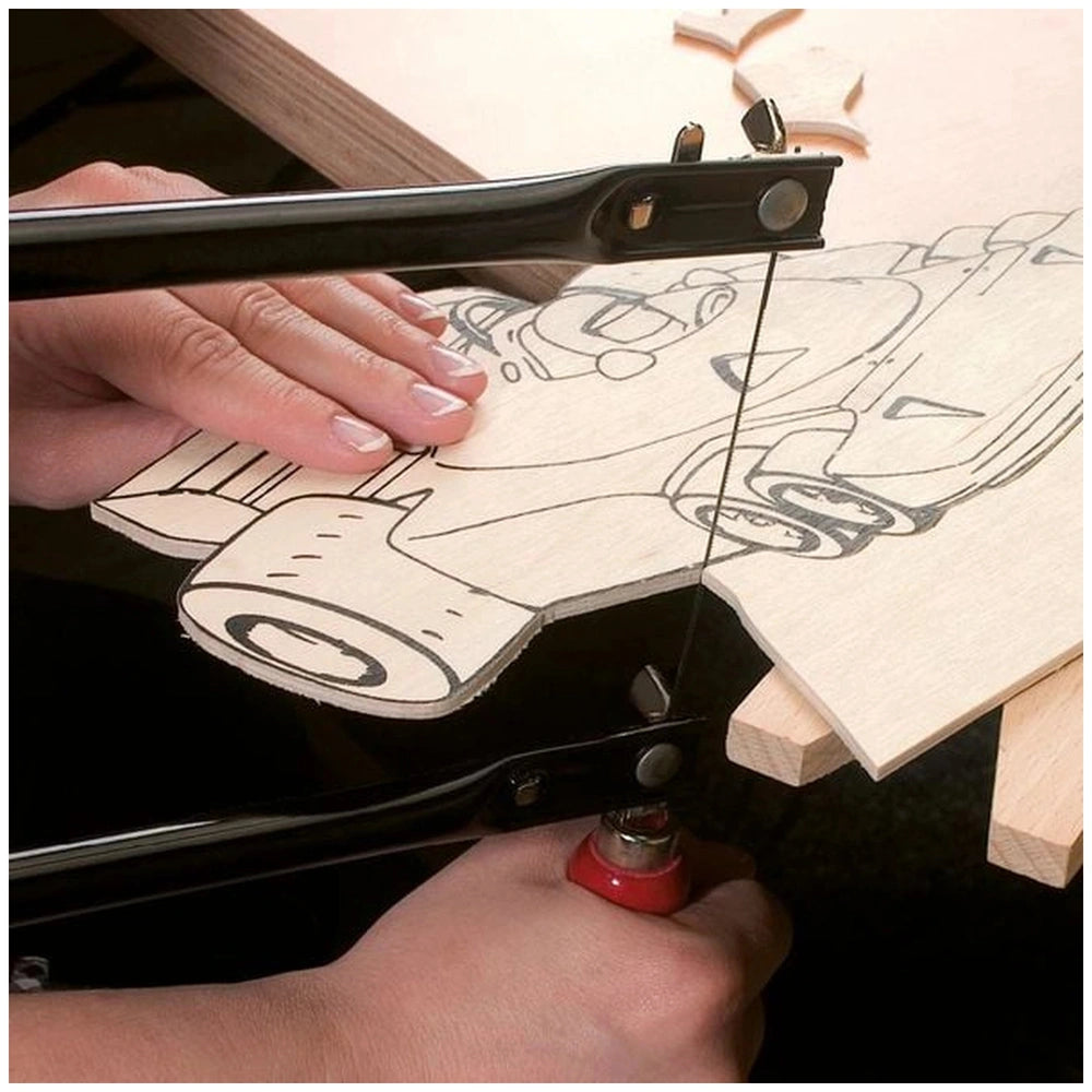 Hands using a saw to cut a design on a Pebaro birch plywood plate, showcasing precision crafting.