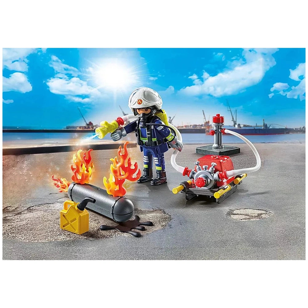 PLAYMOBIL firefighter toy figure with water pump, red and gray fire truck, and orange-yellow flame elements on gray surface.