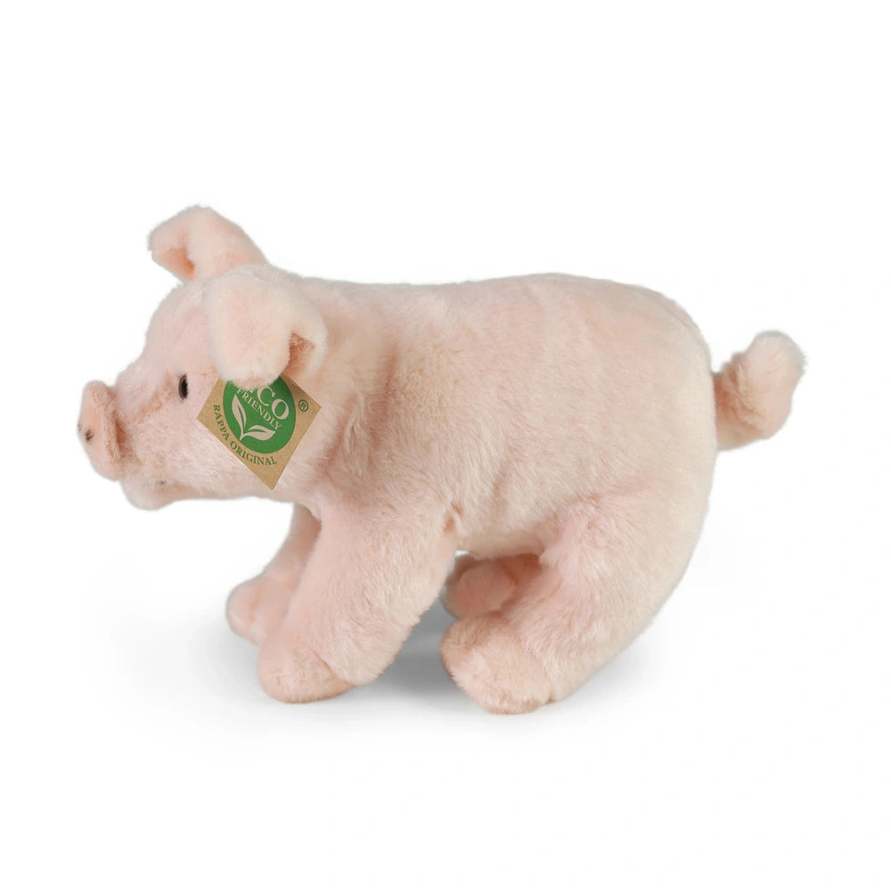 Plush domestic pig toy in soft pastel pink, standing upright with a glossy finish and small black facial features.
