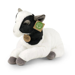 Plush goat with a white body and black markings, sitting on a smooth surface, featuring an eco-friendly tag.