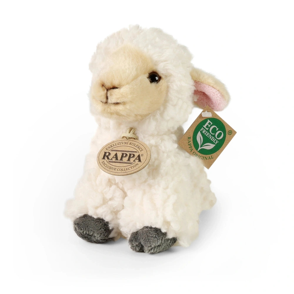 Plush sheep stuffed animal with pink ears and black-tipped feet, featuring an eco-friendly tag with a green leaf symbol.
