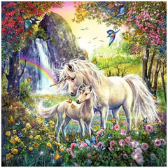 Beautiful unicorns stand in a vibrant field of flowers under a rainbow, showcasing their glossy, flowing manes.